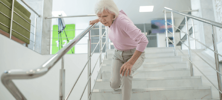 Elderly person struggling to get down stairs