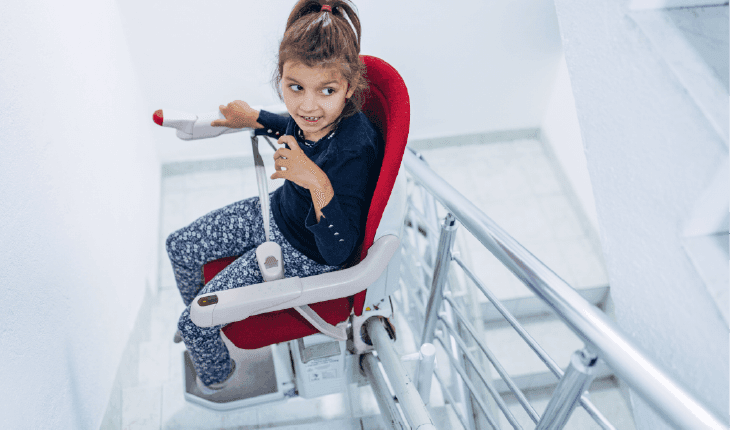 Young girl on sitting stairlift