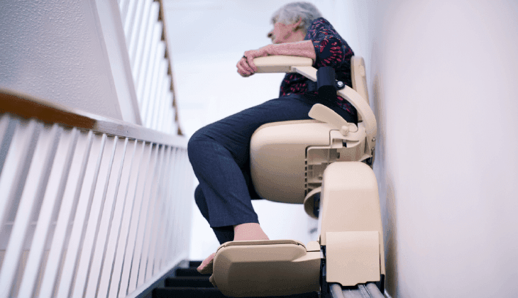 Woman on sitting stairlift